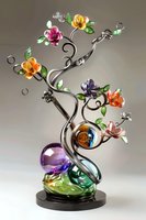 Elegant glass sculpture featuring colorful flowers on curved metallic stems with crystal spheres, set on dark base against neutral background. For art collectors.
