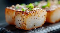 Seared scallops with herbs on dark wooden board, gourmet seafood dish ready for fine dining restaurant menu and culinary presentations.