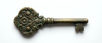 Ornate antique brass key with decorative lion head handle, isolated on white background, suitable for vintage design, steampunk projects, and historical illustrations.