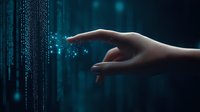 Human hand touching digital interface with glowing particles, creating connection with virtual data stream against dark blue technology background.