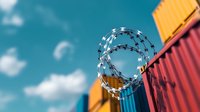 Razor wire coiled atop colorful shipping containers against blue sky with white clouds, creating contrast between industrial security and vibrant cargo storage.