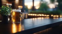 Golden beer mug on wooden bar counter with warm bokeh lights creating cozy pub atmosphere for hospitality and beverage marketing materials.