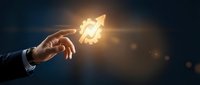Businessman hand holding glowing rocket icon symbolizing startup launch, innovation, and business growth strategy for entrepreneurship and success concepts.