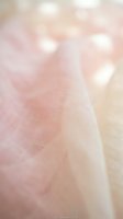 Soft pink tulle fabric with dreamy bokeh lights creating romantic ethereal atmosphere for wedding and feminine design projects.
