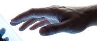 Human hand reaching toward glowing blue light with ethereal energy emanating from palm, suggesting healing power, spiritual connection or futuristic technology concept.