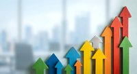 Colorful upward trending arrows in ascending order representing business growth, success and financial progress against blurred office background.