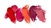 Colorful lipstick smears in red pink orange and purple shades on white background for cosmetic makeup and beauty product advertising campaigns.