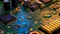 Close-up macro view of electronic circuit board with microchips, resistors, capacitors and golden traces. Technology hardware components for engineering projects.