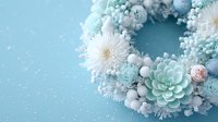 Festive winter wreath with white chrysanthemums, succulents, and blue ornaments on light blue background with snow effect for holiday decoration.