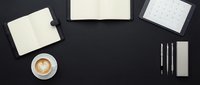Minimalist workspace flat lay with coffee cup, notebooks, calendar and pens on dark background for productivity and planning concepts.