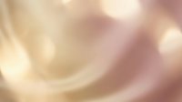 Soft golden pink abstract blur background with warm light bokeh effects for elegant design projects and romantic presentations.