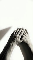 Male hands covering face in despair and stress gesture on white background. Mental health concept for therapy and emotional support materials.
