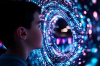 Young Asian boy gazing into glowing circular portal with magical blue and pink bokeh lights creating futuristic atmosphere, side profile view against dark background.