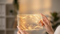 Hands holding glowing transparent glass panel with golden light particles and bokeh effects, suitable for technology, innovation, and digital design projects.