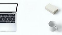 Modern workspace with open laptop, white coffee mug and notepad on clean desk. Minimalist office setup for productivity and remote work concepts.