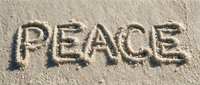 Word PEACE written in sandy beach, natural texture background, calm and serene concept for meditation, travel, and mindfulness designs.