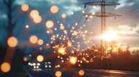 Electricity transmission tower silhouette at sunset with glowing network connections and bokeh lights overlay, representing power grid and smart energy technology.