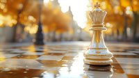 White queen chess piece on checkered board with golden bokeh background, dramatic low angle perspective highlighting strategy and leadership concept.