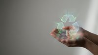 Hands holding glowing recycling symbol with light effects, representing sustainable business, environmental responsibility, and green energy solutions for corporate and eco-friendly design projects.
