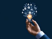 Businessman hand holding glowing lightbulb with AI icons floating above on dark blue background, representing innovation and artificial intelligence concepts.