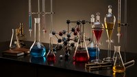 Chemistry laboratory equipment with colorful liquids in glass beakers and flasks for scientific research and experimentation in modern lab setting.