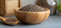 Raw chia seeds in wooden bowl and spoon on gray background, healthy superfood rich in omega-3 fatty acids and fiber, natural organic ingredient.