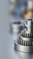Precision machined metal gears and components on industrial workbench showcasing manufacturing excellence and engineering craftsmanship.