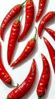 Red chili peppers arranged on white background, isolated fresh produce for culinary, cooking, and food design projects.