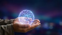 Hand holding glowing digital brain sphere with neural network connections, representing artificial intelligence, technology innovation, and futuristic computing solutions.