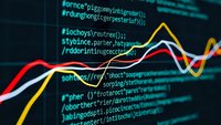 Colorful data visualization charts overlaying computer programming code on dark screen for business analytics and software development projects.