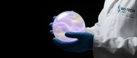 Scientist in white lab coat and blue gloves holding glowing translucent sphere against dark background, representing innovation, technology, research, and scientific discovery for educational and corporate use.