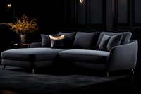 Modern dark gray L-shaped sectional sofa with chaise lounge on black background, illuminated by warm accent lighting, featuring elegant curved design and plush cushions.