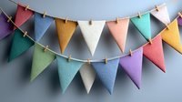 Colorful triangular bunting flags in pastel shades hanging on string against blue wall, perfect for party decoration or festive home decor.