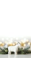 White ceramic llama figurine with decorative saddle blanket positioned among fresh evergreen branches and warm golden bokeh lights, isolated on white background for holiday greeting cards, seasonal marketing materials, and festive design projects.