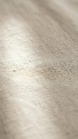 Natural linen fabric texture with soft beige color and organic weave pattern for textile design backgrounds and fashion projects.