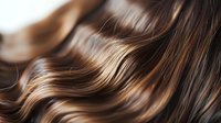 Luxurious brown wavy hair with highlights flowing in smooth curves, showcasing healthy shine and natural movement for beauty and haircare advertising.