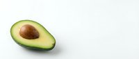 Fresh halved avocado with pit on white background, isolated for healthy food, nutrition, and organic diet design projects.