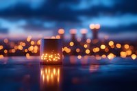 Glowing lantern with fairy lights on reflective surface against blurred city bokeh lights and moody blue twilight sky, creating magical atmosphere.