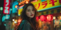 Young Asian woman with long dark hair in vibrant neon-lit urban street at night with colorful signs and bokeh lights for lifestyle and travel content.