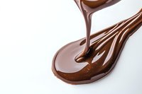 Liquid chocolate pouring from above into glossy brown puddle on white surface, creating smooth flowing texture and reflective surface for confectionery designs.