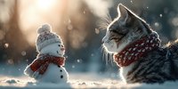 Adorable tabby kitten wearing knitted scarf sits next to small snowman with matching scarf during gentle snowfall with warm sunlight creating magical winter scene.