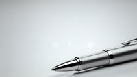 Elegant silver ballpoint pen with chrome accents on clean white background for business and professional writing applications.