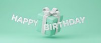 Mint green gift box with white ribbon bow floating beside Happy Birthday text on a pastel turquoise background for greeting cards.