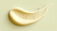 Luxurious golden cream smear with small bubbles on light background, cosmetic product texture showing moisturizing properties for skincare advertising.