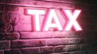 Glowing pink neon TAX sign mounted on textured brick wall creates dramatic lighting effect and modern urban atmosphere for business and finance concepts.