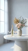 Elegant champagne bottle with glasses and floral arrangement on marble table by window in modern minimalist interior for celebration and luxury lifestyle.