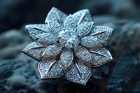 Elegant silver flower brooch with sparkling crystals on dark stone surface for luxury jewelry and fashion accessories.