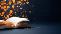 Open book with glowing magical light and orange bokeh particles floating up against dark background, creating mystical atmosphere for education and literature concepts.