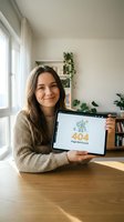 Young woman with long dark hair and South Asian ethnicity holding tablet displaying 404 error page in bright home office with plants and natural window light, representing web design and digital communication concepts.