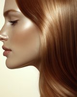 Profile of young woman with glowing skin and flowing brown hair against light background, highlighting natural beauty and haircare concept.